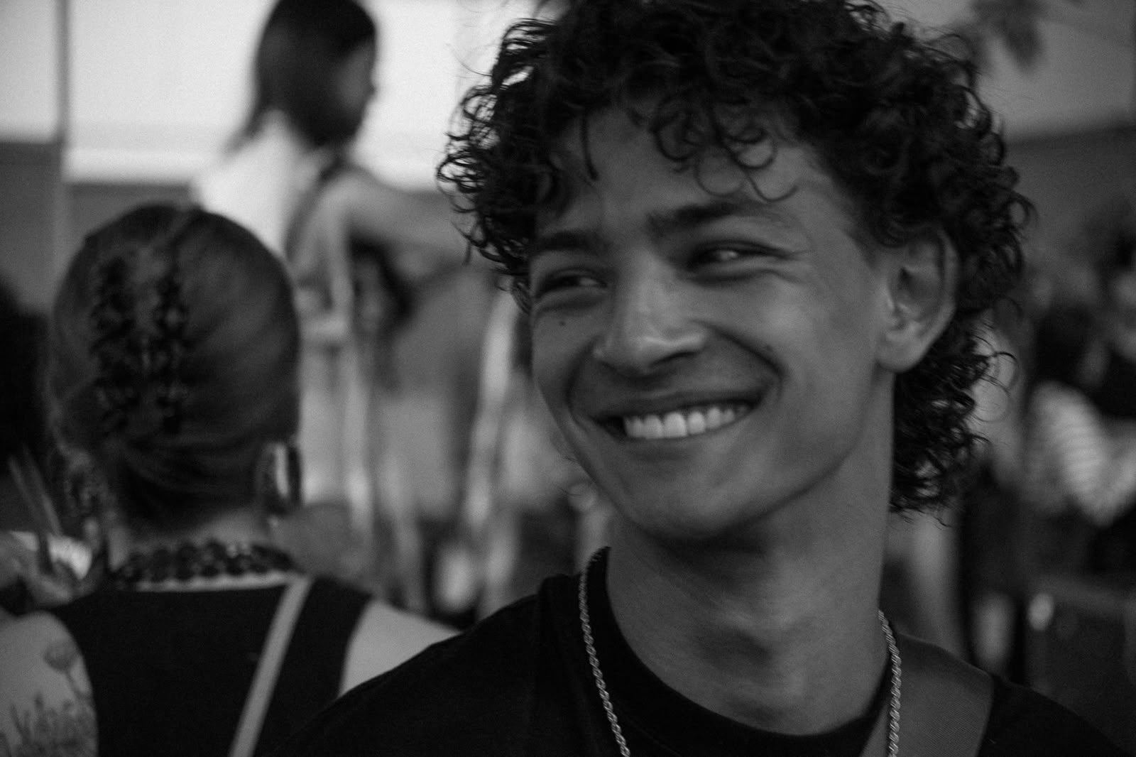 Tygo smiling in a black-and-white portrait